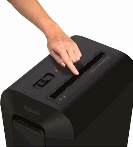 Fellowes LX65 paper shredder in black with 22-liter capacity, shown with shredded paper and paper sheets for office use.