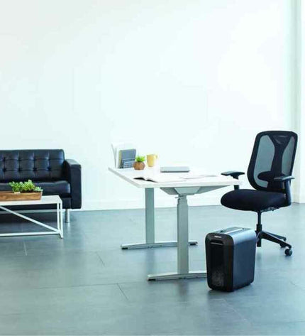 Fellowes LX65 paper shredder in black with 22-liter capacity, shown with shredded paper and cutting blades.