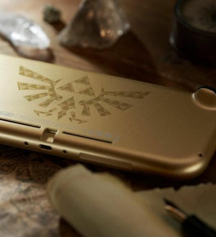 Nintendo Switch Lite Hyrule Edition in gold, compact gaming console with Hyrule-themed design, perfect for portable gaming.