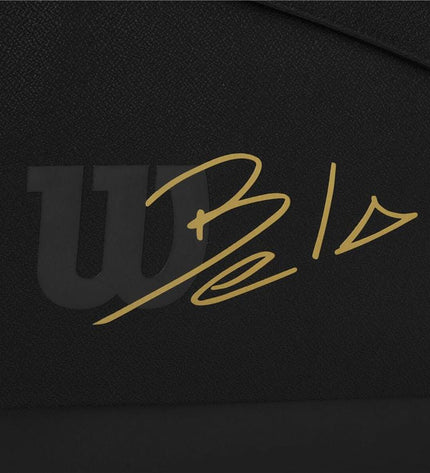 Wilson Bela Super Tour paddle tennis racket in black, with a sleek grip and Wilson branding, designed for outdoor sport play.