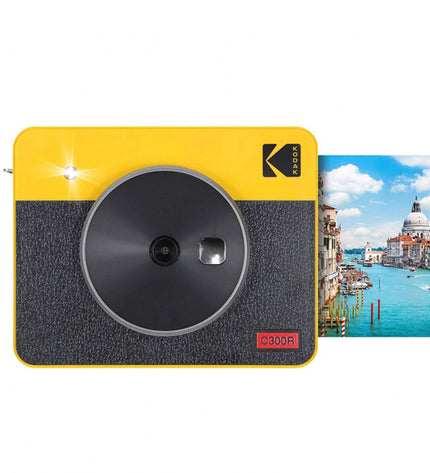 Kodak C300RY digital camera with lens, display screen, and optical viewfinder, capturing a professional photography device.