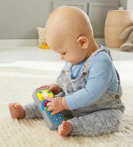 Fisher-Price Laugh and Learn Doggy toy for babies, featuring colorful buttons and a friendly dog design, measuring 10x5x21 cm.