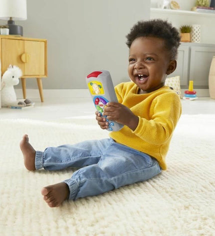 Fisher-Price Laugh and Learn Doggy baby toy remote control, colorful plastic, measuring 10x5x21 cm, for young children.