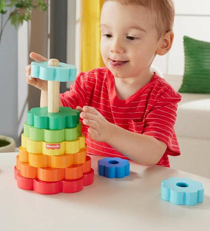 Fisher-Price Blokken Stapelen speelgoed for babies with 10 colorful stacking blocks and a smiling baby playing with them.