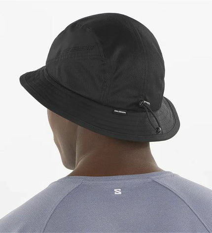 Black Salomon Shkout bucket hat for outdoor activities, camping, and hiking, with wide brim and durable fabric.