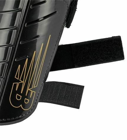 Black New Balance Nclasp Flex football shin guards with padded protection for sport and outdoor soccer.