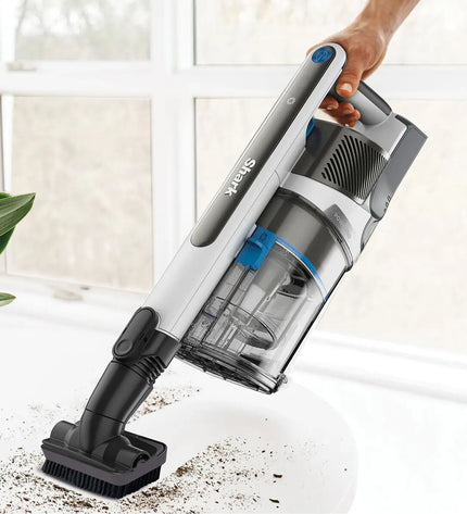 Shark IZ380EUT steel vacuum cleaner in a home setting, showcasing its sleek design for cleaning floors and surfaces.