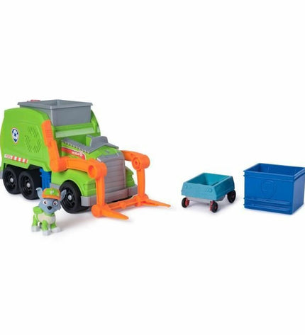 Spin Master Rocky Paw Patrol action figure with green uniform and accessories, posed in a play setting.