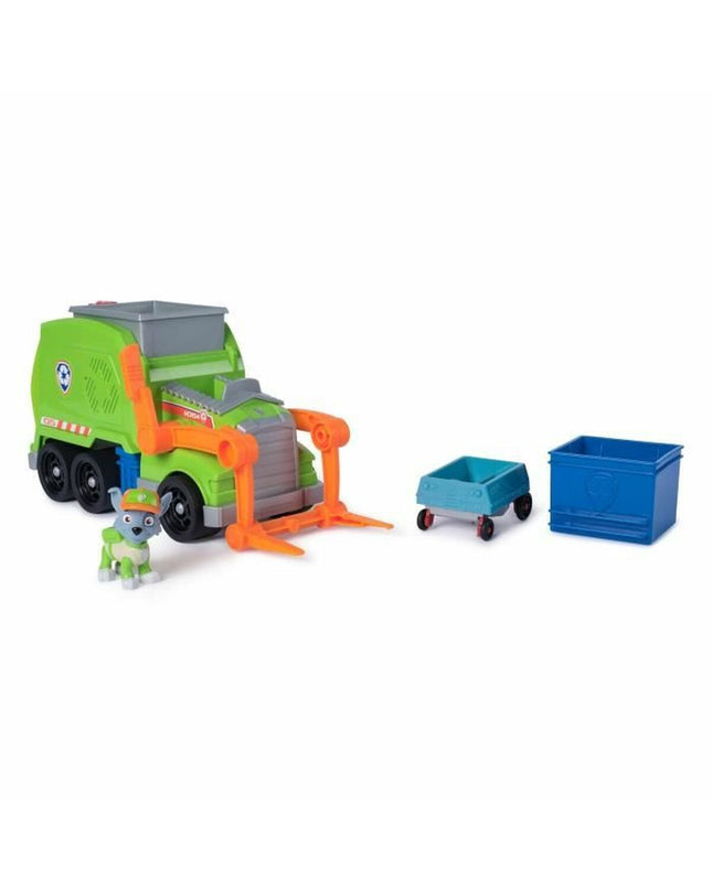 Spin Master Rocky Paw Patrol action figure with green uniform and accessories, posed in a play setting.