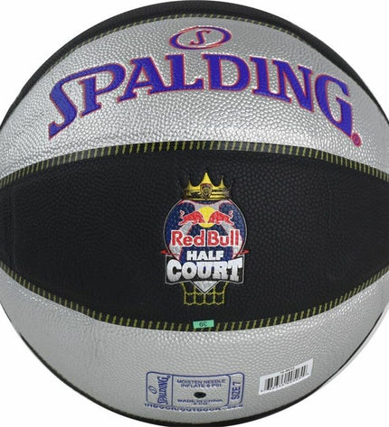 Spalding TF-33 basketball in red and black, size 7, designed for outdoor sports, with textured surface and brand logo visible.