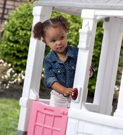 Step 2 Courtyard Cottage toy playhouse for children, outdoor play structure with windows and door, ideal for kids’ outdoor fun.
