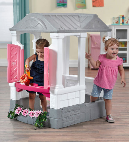 Step 2 Courtyard Cottage playhouse for kids, colorful wooden toy house with windows and door, outdoor play equipment for children