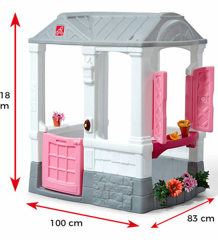 Step 2 Courtyard Cottage playhouse for kids, outdoor toy with windows and door, designed for outdoor play and imaginative fun.