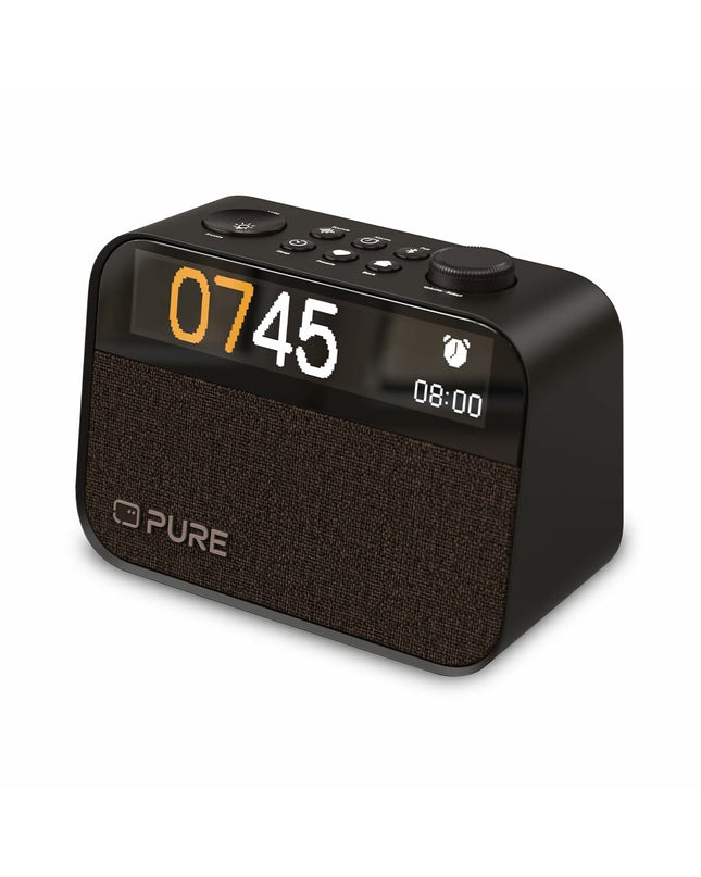 Pure MOMENT radio alarm clock showing digital display and control buttons, modern electronic audio device on a clean surface.