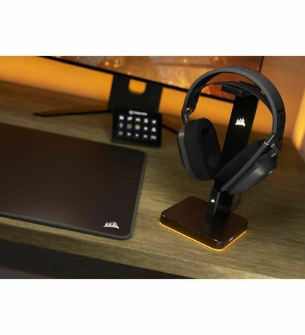 Corsair HS80 MAX gaming headset with microphone, black over-ear design, connected to a gaming console for immersive audio.