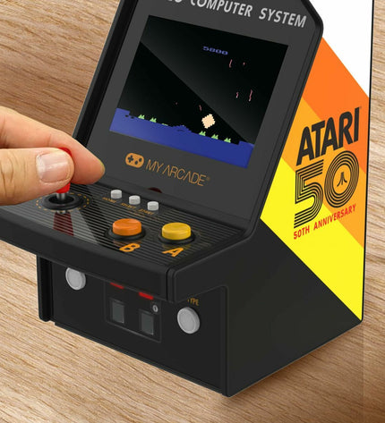 My Arcade portable retro game computer showing colorful screen with classic arcade game graphics and controls.