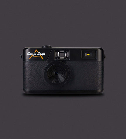 Camp Snap digital camera CS-V105-BK-WW in black, showing front view with lens, buttons, and compact design for photography and video.