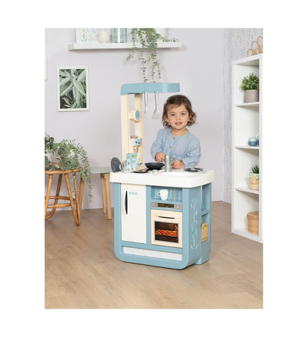 Beige and blue Smoby Bon Appetit toy kitchen with stove, sink, and storage compartments, designed for imaginative play.