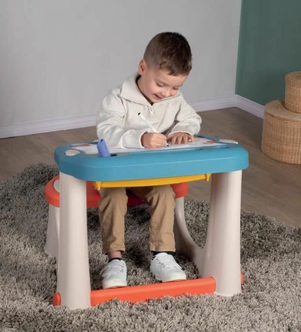 Blue Smoby Rek Smoby Magic desk for kids, featuring a playful house and kitchen furniture setup in vibrant colors.