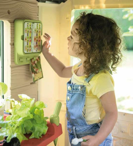 Smoby Life Garden children's toy playhouse for outdoor play, featuring colorful plastic walls and a small door, suitable for kids.