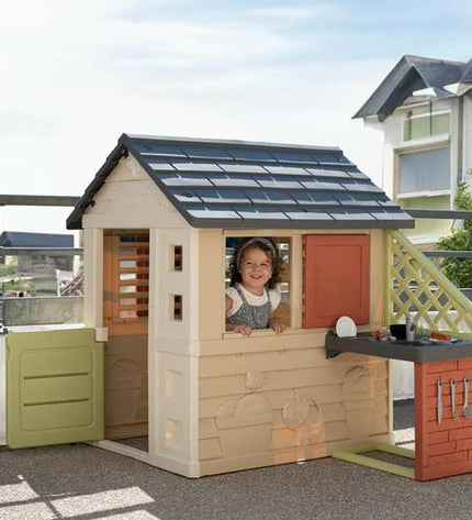Smoby Nature children's playhouse made of durable plastic, featuring a small door, windows, and colorful exterior for outdoor fun