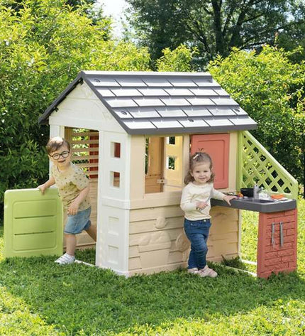 Smoby Nature children's playhouse made of colorful plastic, designed for outdoor fun and imaginative play in the garden.