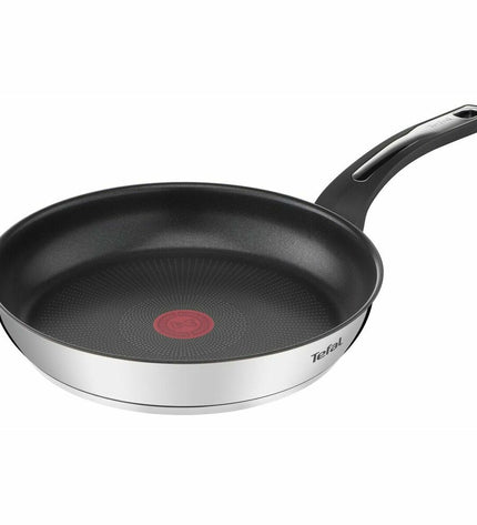 Stainless steel Tefal E3000404 24cm frying pan for home cooking, with a durable non-stick surface and ergonomic handle.