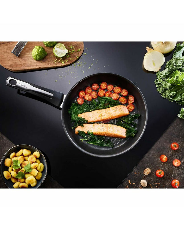 Stainless steel Tefal E3000404 24cm frying pan, suitable for home cooking, with a durable stainless steel handle and flat base.