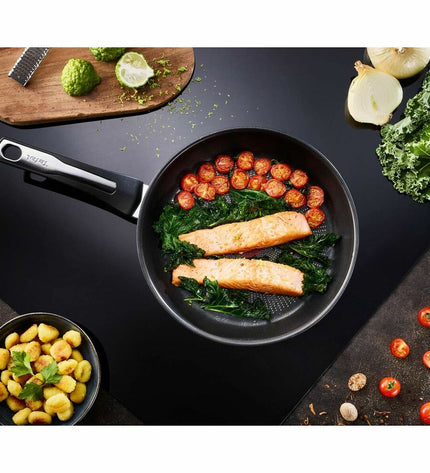 Tefal E3000604 28cm stainless steel frying pan for home cooking, with a shiny, durable cookware surface.