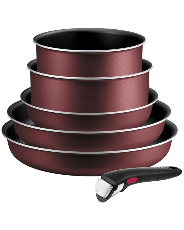 Set of six Tefal aluminium cookware pans for home cooking, including various sizes, shown in a kitchen setting.