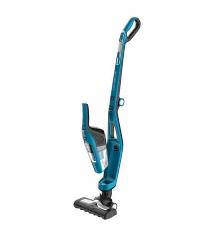 Rowenta Dual Force cordless steel vacuum cleaner with 0.6L capacity and 21.6V battery, shown cleaning a floor in a home setting.