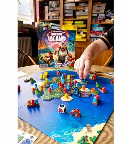 Asmodee Survive The Island board game with colorful cards and game pieces for family fun and strategic play.
