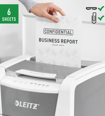 Leitz IQ 150 Microsnippers paper shredder for office use, showing compact design and cutting blades in action.
