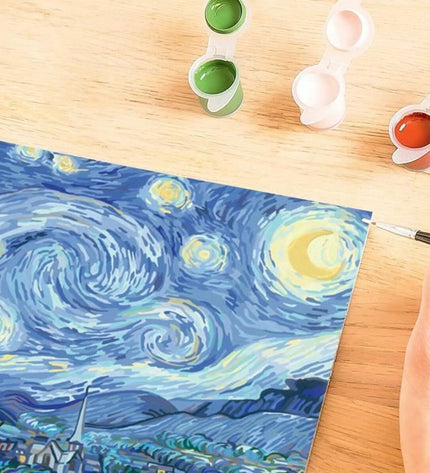 Ravensburger CREART Van Gogh board game with colorful artwork and game pieces on a table.