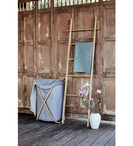 Wenko Bahari Trap bamboo towel rack in bathroom, with multiple bars for hanging towels and a sleek, natural bamboo finish