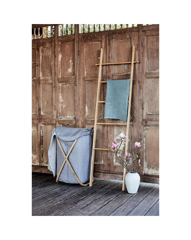 Wenko Bahari Trap bamboo towel rack in bathroom, with multiple bars for hanging towels and a sleek, natural bamboo finish