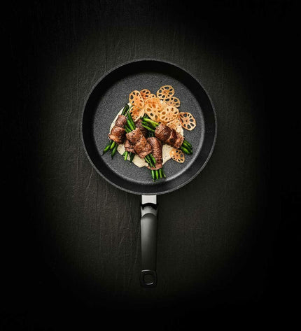 Fissler 15910520100/0 black aluminum 20cm frying pan for home cooking, with sturdy handle and non-stick surface.