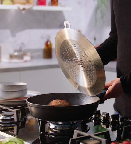 Fissler 24cm black aluminum frying pan, house and kitchen cookware, with sturdy handle and non-stick surface.