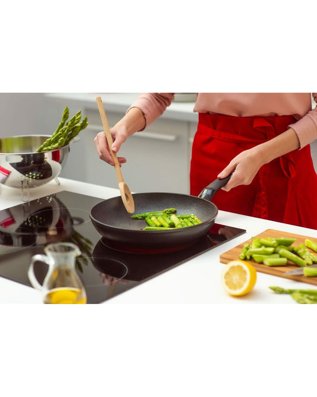 Fissler ADAMAT CLASSIC black kitchen spatula with a sturdy handle and slotted design for cooking and stirring.
