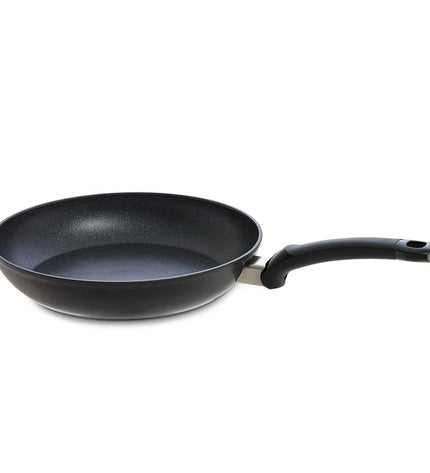 Fissler ADAMAT CLASSIC black aluminium cookware for home cooking, showing the sleek black pan with handle and lid on a kitchen surface.