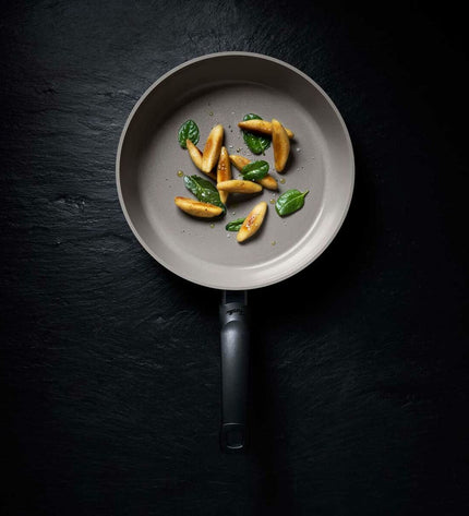 Fissler aluminium cookware pan in grey metal, suitable for home cooking, with a sleek, durable design.