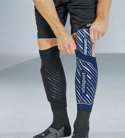 Blue Uhlsport Speedshield football shin guards designed for soccer, featuring lightweight, protective padding and adjustable straps.