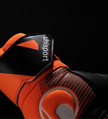 Uhlsport Keeperhandschoenen Soft Ressist+ in orange for adults, designed for football goalkeeping, with padded palms and adjustable straps.