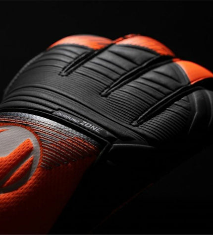 Uhlsport Keeperhandschoenen Soft Ressist+ in orange for adults, designed for soccer goalkeeping, with padded palms and adjustable wrist straps.