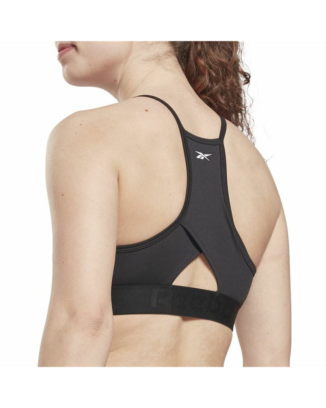 Reebok black sport bra with strappy design, suitable for outdoor and cycling activities, shown on a model.