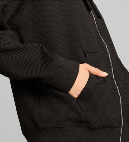 Puma women's sport jacket in black and pink, lightweight outdoor sportswear, with zip-up front and breathable fabric.