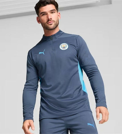 Puma Manchester City training sweatshirt for adults, sporty football apparel, shown in a close-up of the sweatshirt's fabric and logo.