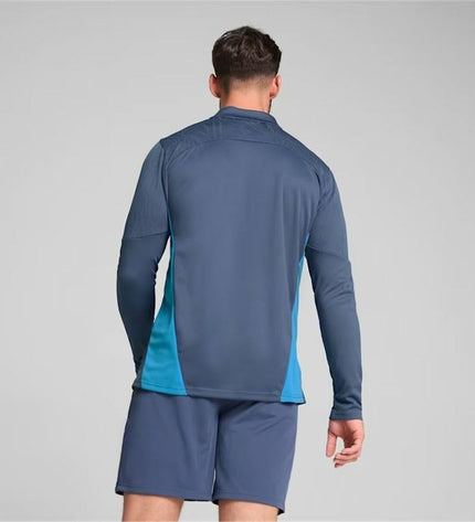 Puma Manchester City adult training sweatshirt in blue, featuring team logo, designed for soccer and outdoor sports.