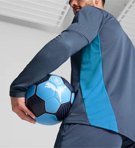 Puma Manchester City adult training sweatshirt in blue for football, showing the front with team logo and athletic fit.