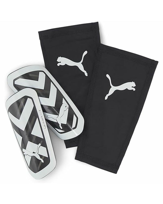 Puma Ultra Flex Sleeve football shin guards in black with white branding, designed for sport and outdoor soccer protection.